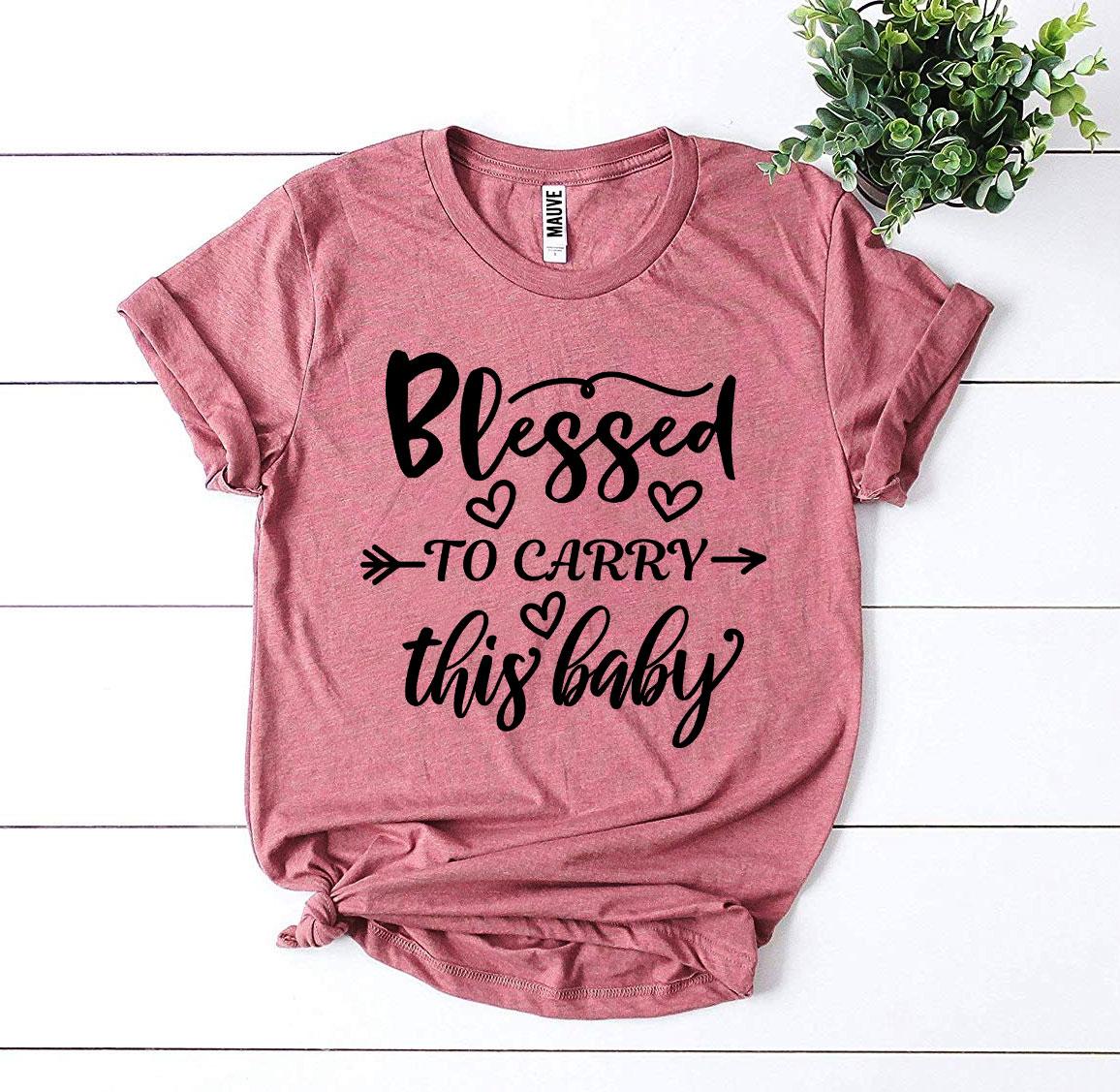 Blessed To Carry This Baby T-shirt made of soft ring spun cotton, featuring a high-quality flex print design.