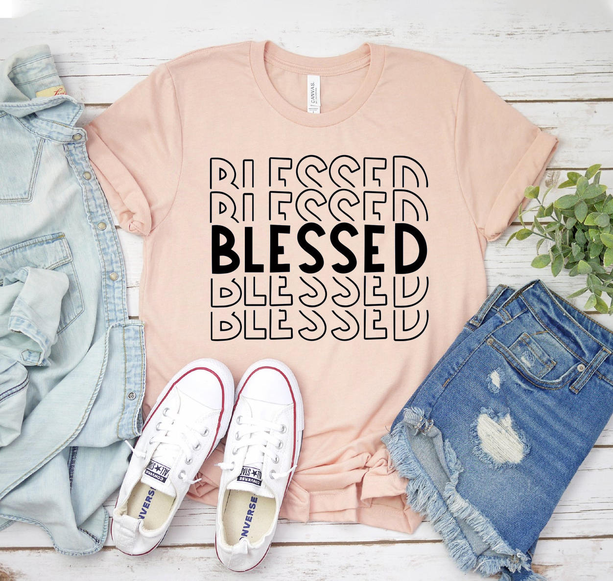 A stylish Blessed T-shirt made from soft airlume cotton, showcasing its classic unisex design and available in various sizes.