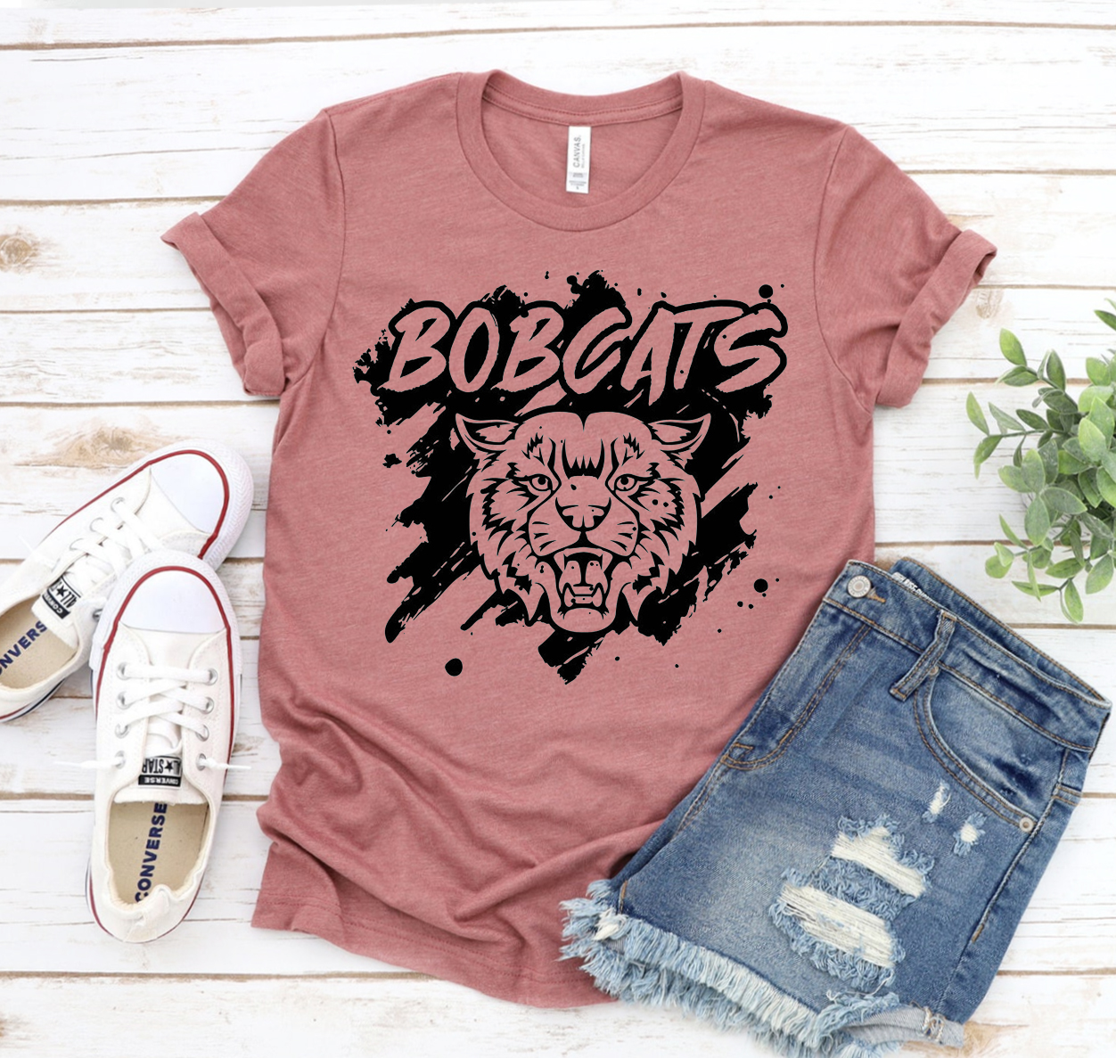 A classic unisex Bobcats T-shirt made from soft airlume combed cotton, displayed on a hanger with a neutral background.