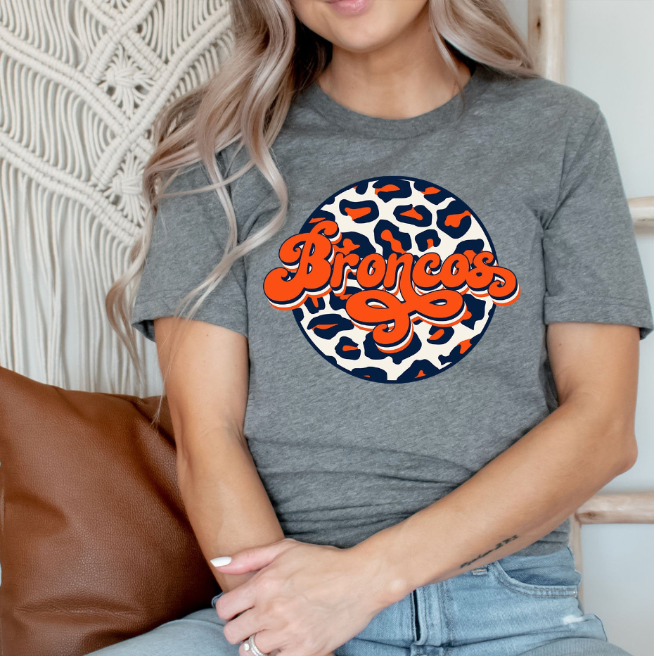 Broncos Retro Leopard Circle Unisex T-shirt featuring a vibrant leopard print design, perfect for fans and casual wear.