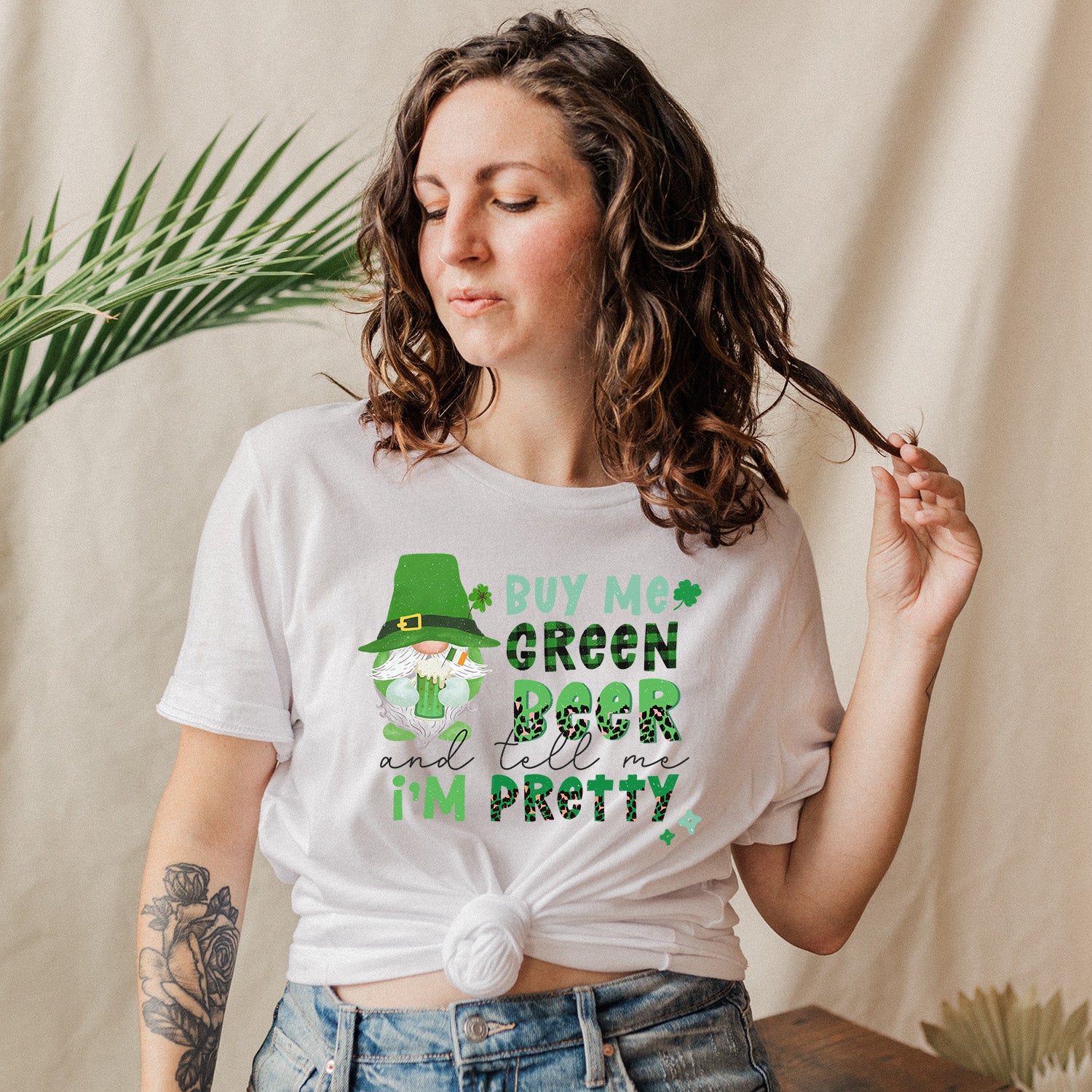 A unisex t-shirt featuring the phrase 'Buy Me Beer and Tell Me I'm Pretty' in a playful font, showcasing its vibrant design.