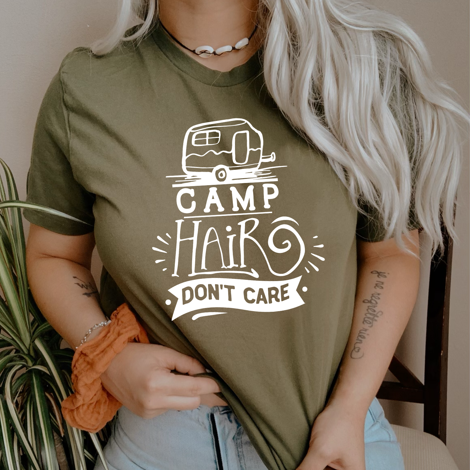 A stylish unisex T-shirt featuring the phrase 'Camp Hair Don't Care' printed in vibrant colors, perfect for outdoor enthusiasts.