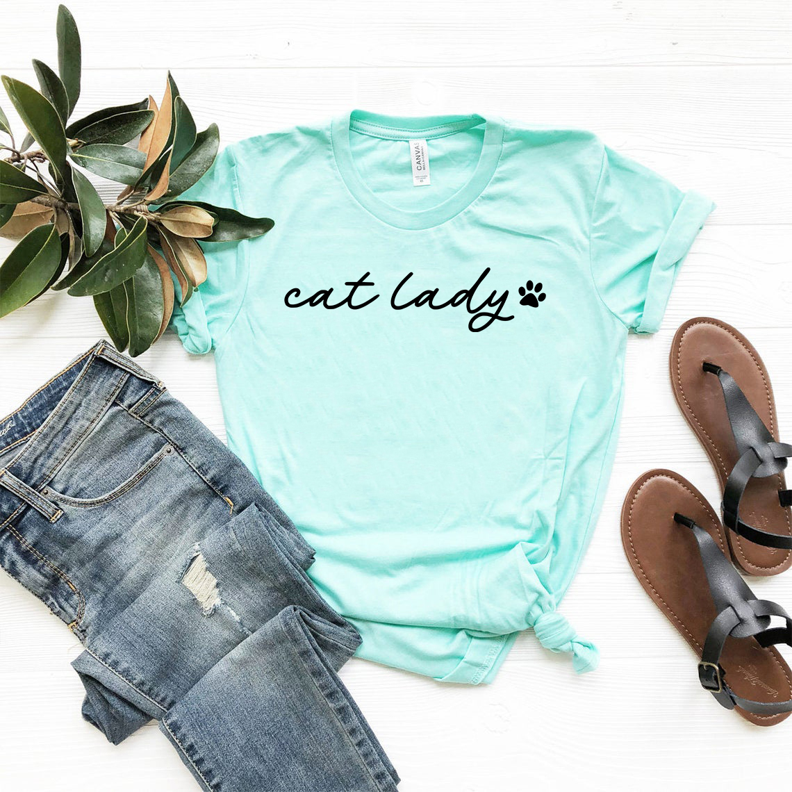 A stylish unisex Cat Lady Shirt made from soft ring spun cotton, featuring a classic crew neck and short sleeves, available in multiple colors.