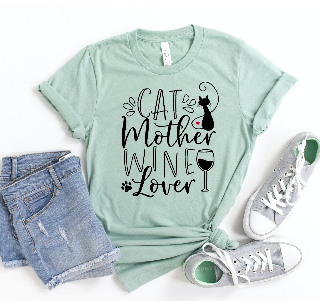 A stylish Cat Mother Wine Lover T-shirt displayed on a hanger, showcasing its soft fabric and unisex design.