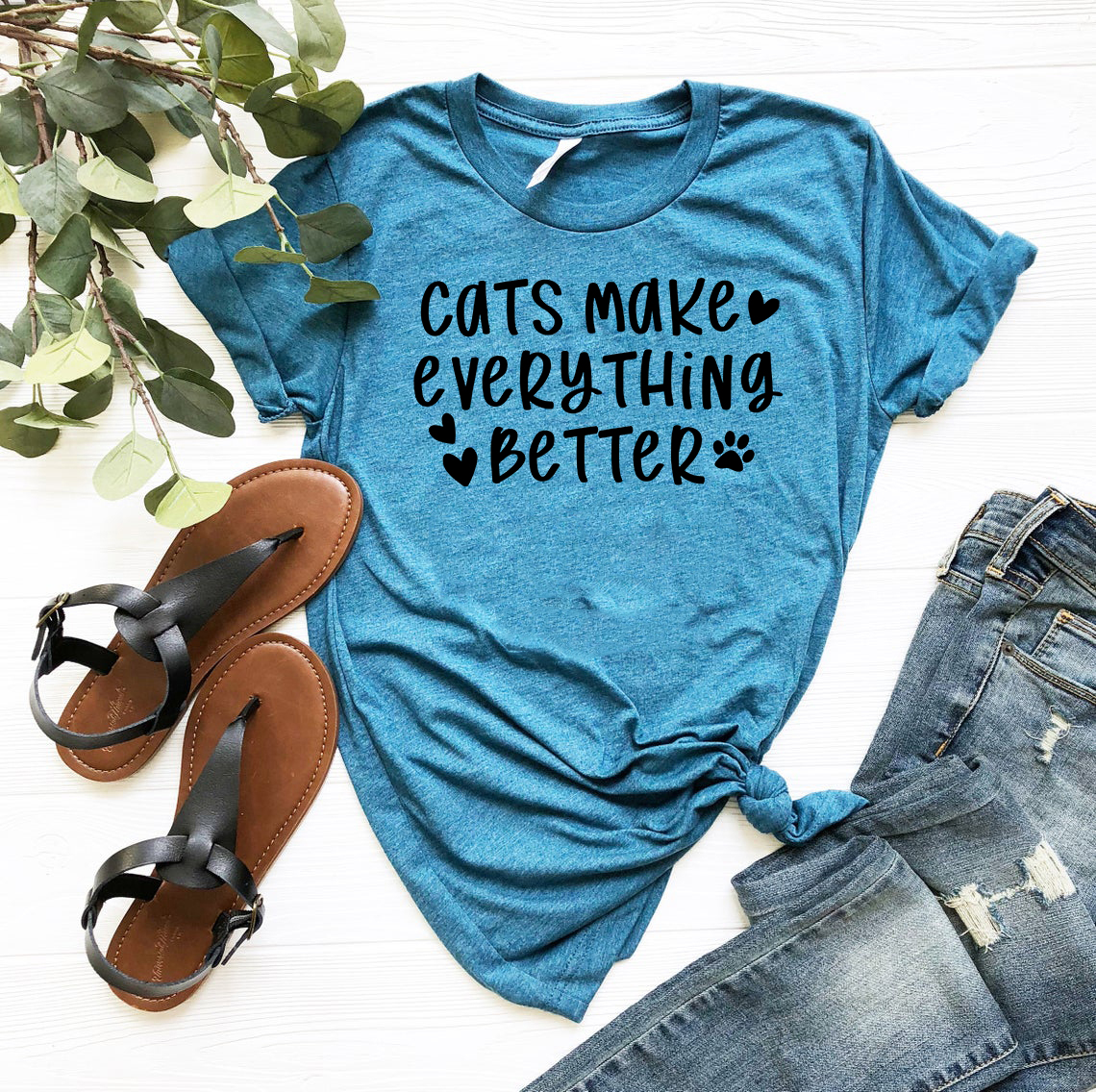 A comfortable unisex T-shirt featuring the phrase 'Cats Make Everything Better' in a stylish print, available in various colors.