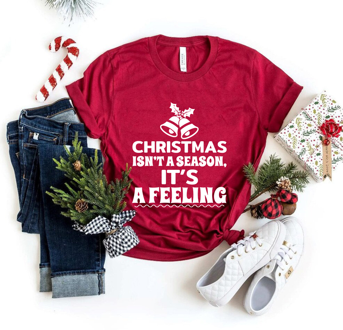 Unisex T-shirt featuring the phrase 'Christmas Is Not A Season Its A Feeling' in festive colors, made from soft ring spun cotton.