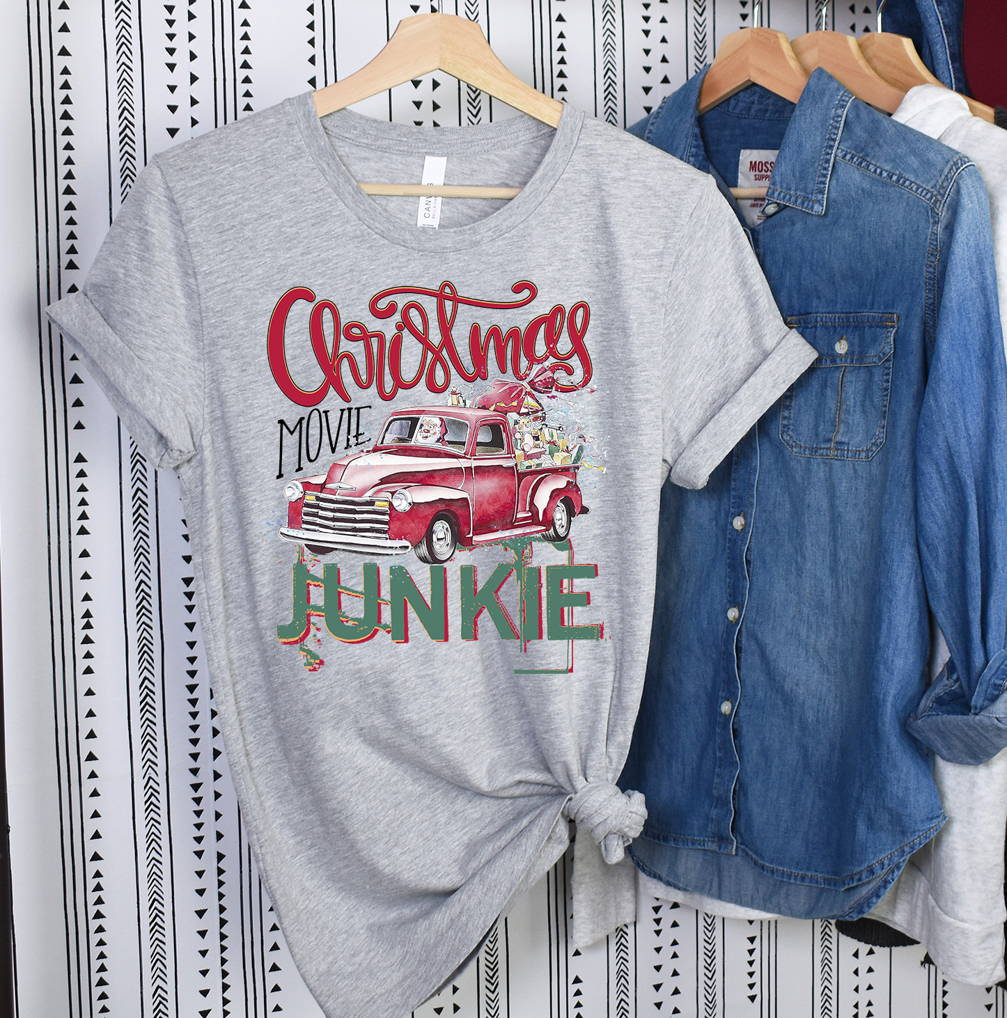 A Christmas Movie Junkie Unisex T-shirt featuring vibrant holiday-themed graphics, perfect for movie lovers.