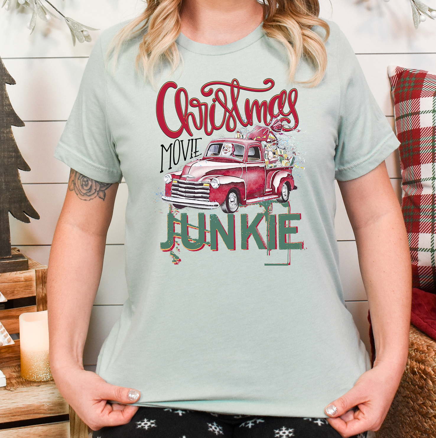 A Christmas Movie Junkie Unisex T-shirt featuring vibrant holiday-themed graphics, perfect for movie lovers.