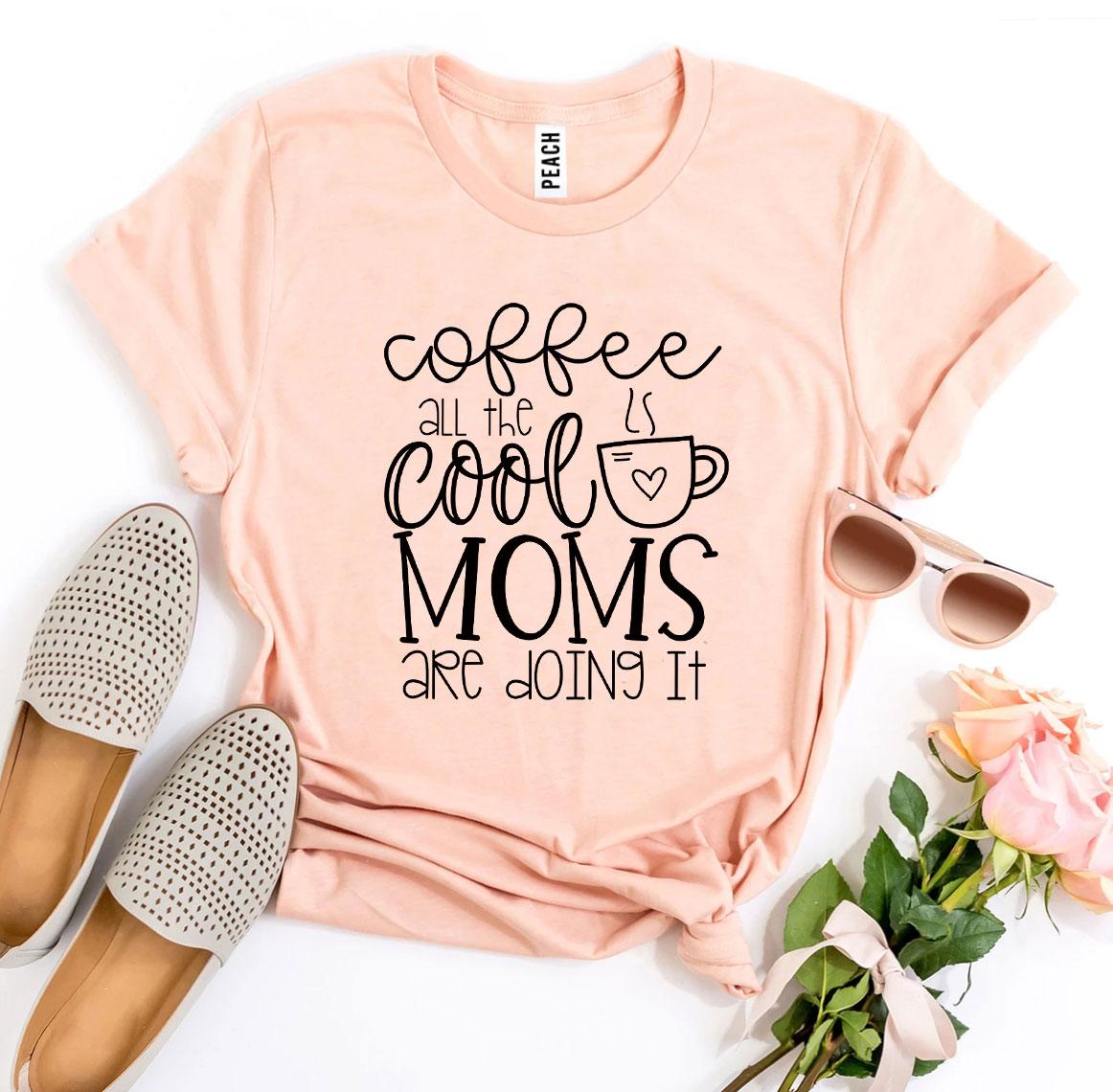 A stylish t-shirt featuring the phrase 'Coffee All The Cool Moms Are Doing It', made from soft ring spun cotton.