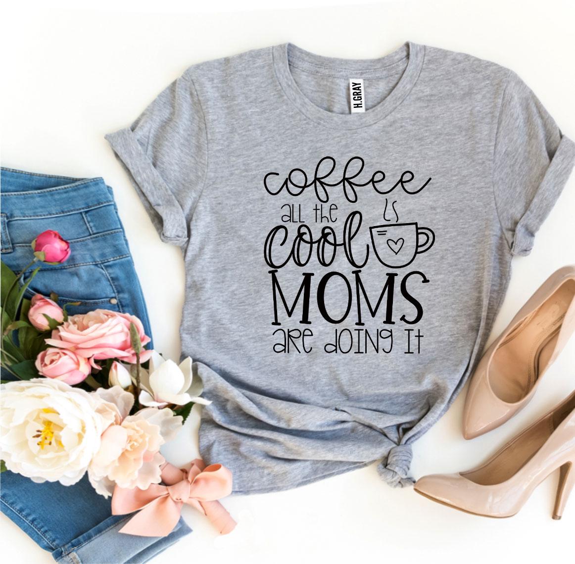 A stylish t-shirt featuring the phrase 'Coffee All The Cool Moms Are Doing It', made from soft ring spun cotton.