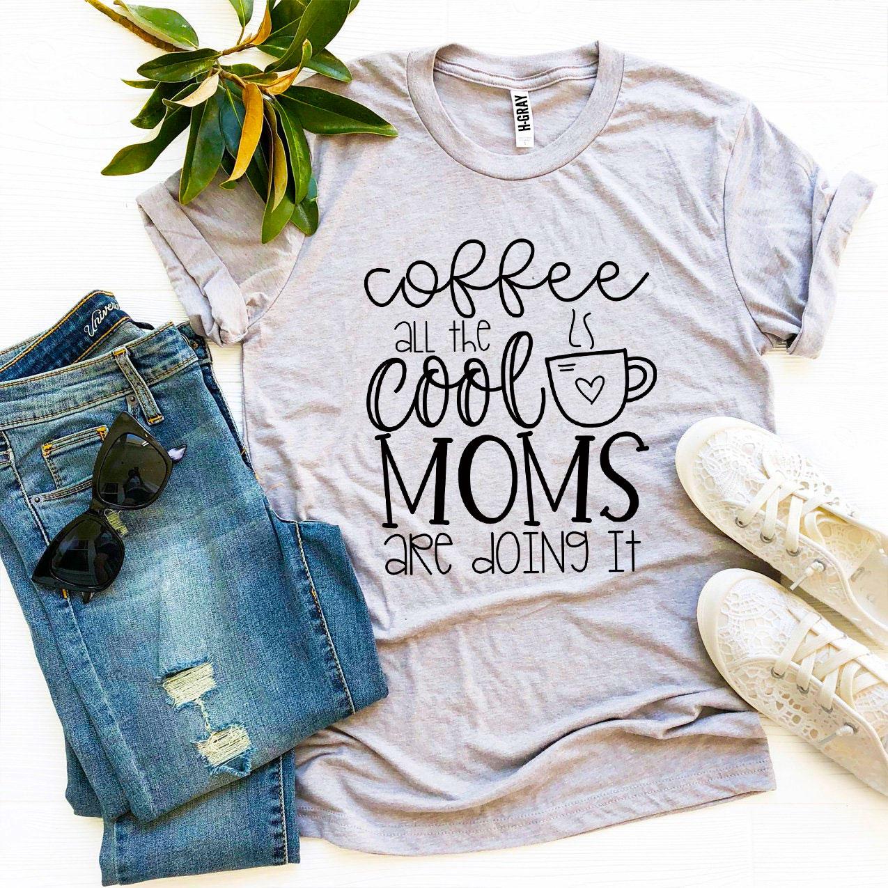 A stylish t-shirt featuring the phrase 'Coffee All The Cool Moms Are Doing It', made from soft ring spun cotton.