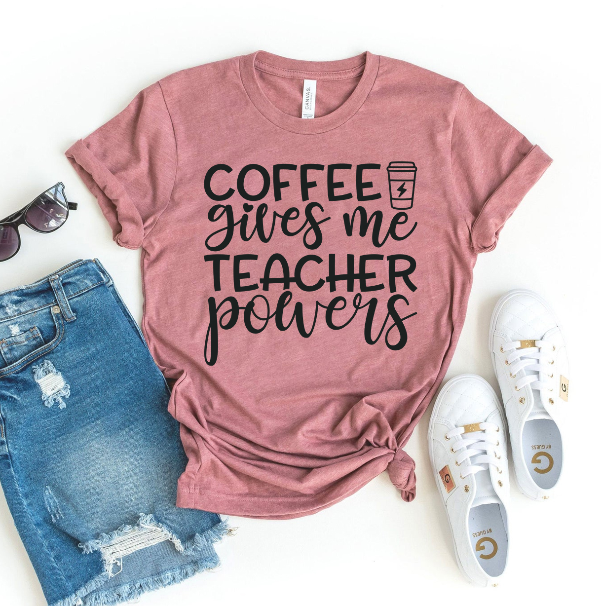 A stylish black T-shirt featuring the phrase 'Coffee Gives Me Teacher Powers' in bold lettering, made from premium quality cotton.