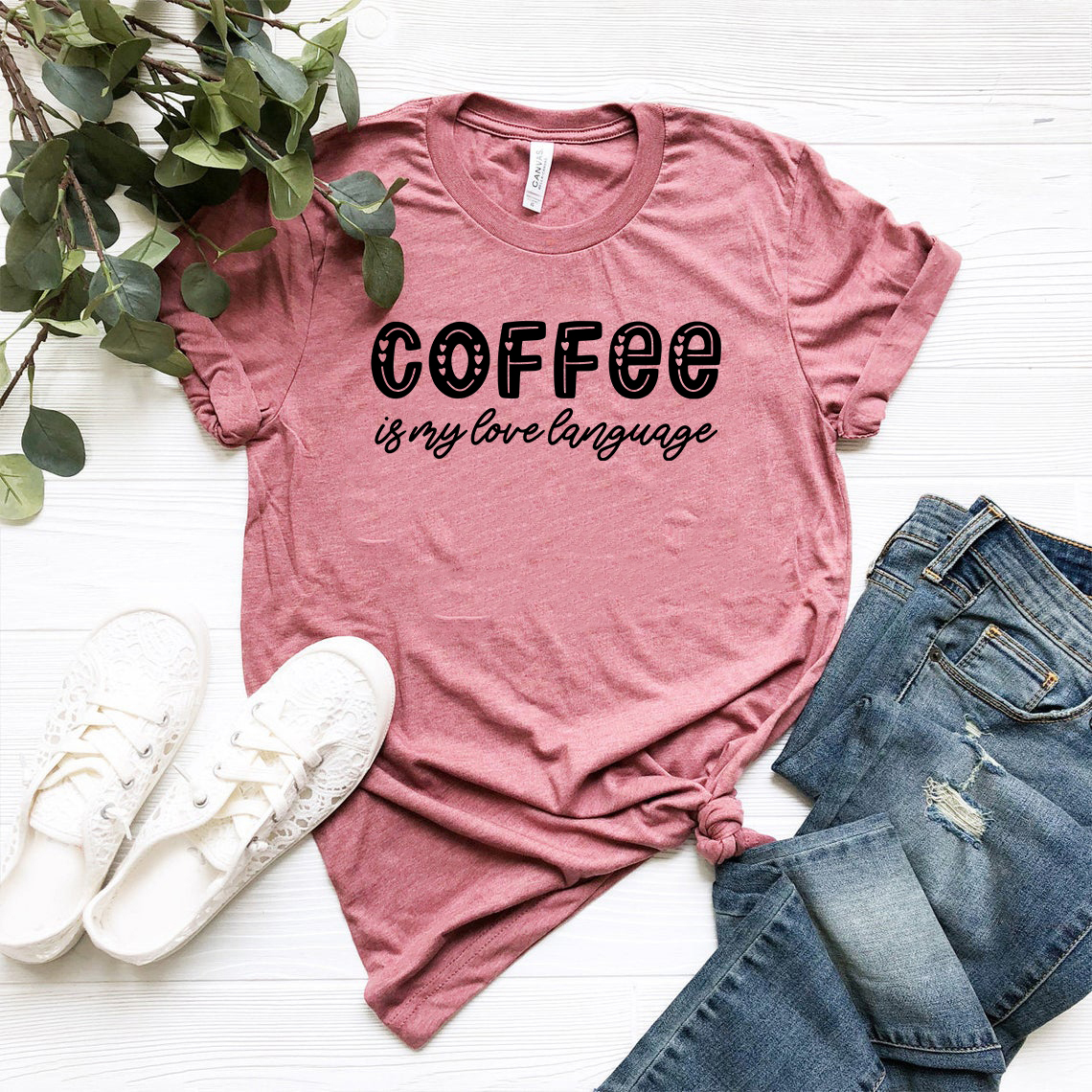 A unisex Coffee Is My Love Language Shirt in various colors, showcasing its soft fabric and stylish design.