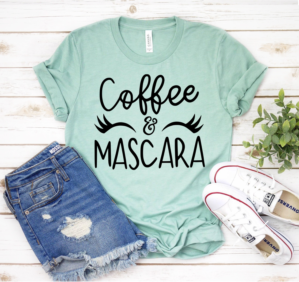 A stylish unisex Coffee & Mascara T-shirt made from soft airlume cotton, featuring a trendy design perfect for casual wear.