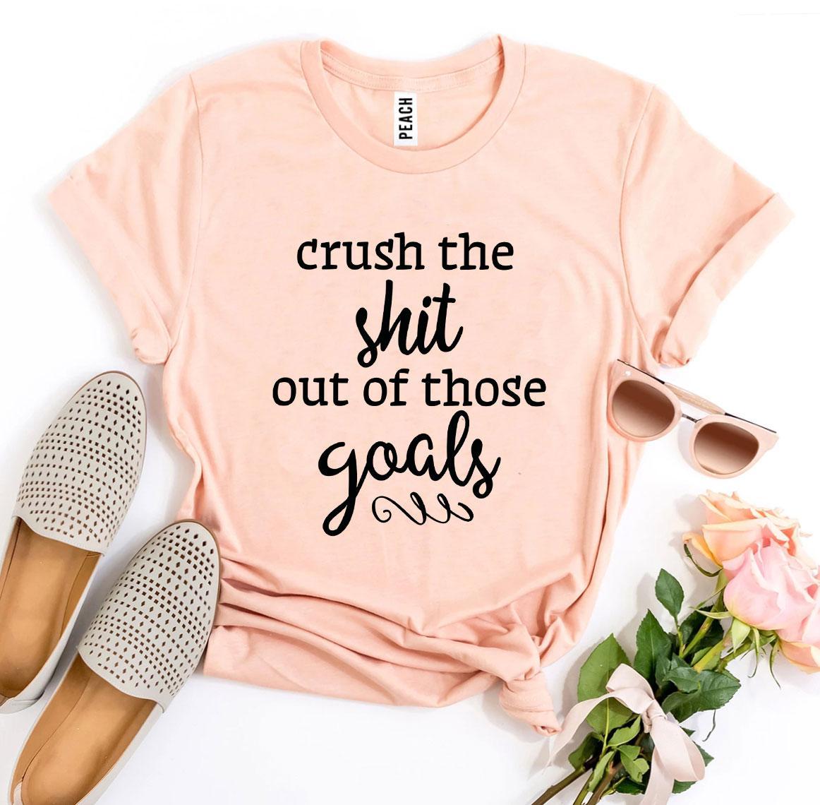 A stylish black t-shirt with the phrase 'Crush The Shit Out Of Those Goals' printed in bold white letters, showcasing its premium quality and soft fabric.