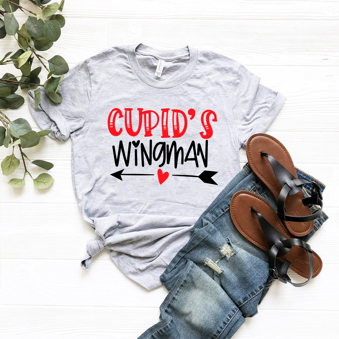 A stylish unisex Cupid's Wingman Shirt in various colors, showcasing its soft fabric and classic crew neck design.