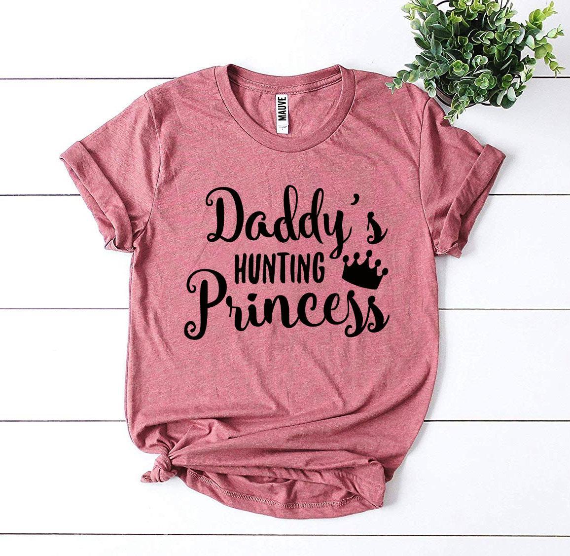 A stylish Daddy’s Hunting Princess T-shirt made from premium ring spun cotton, featuring a playful hunting princess design.