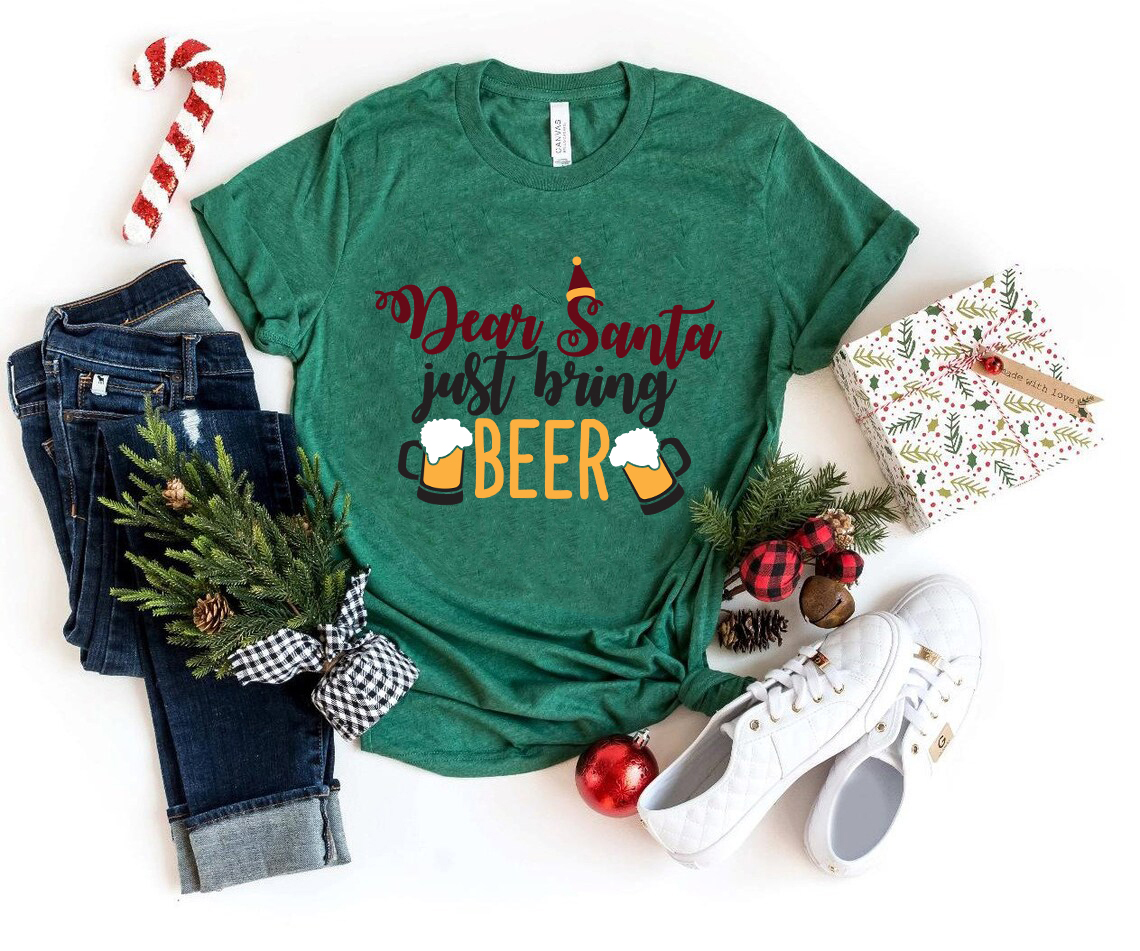 A festive unisex T-shirt featuring the phrase 'Dear Santa Bring Beer' in a fun, holiday-themed design, available in multiple colors.