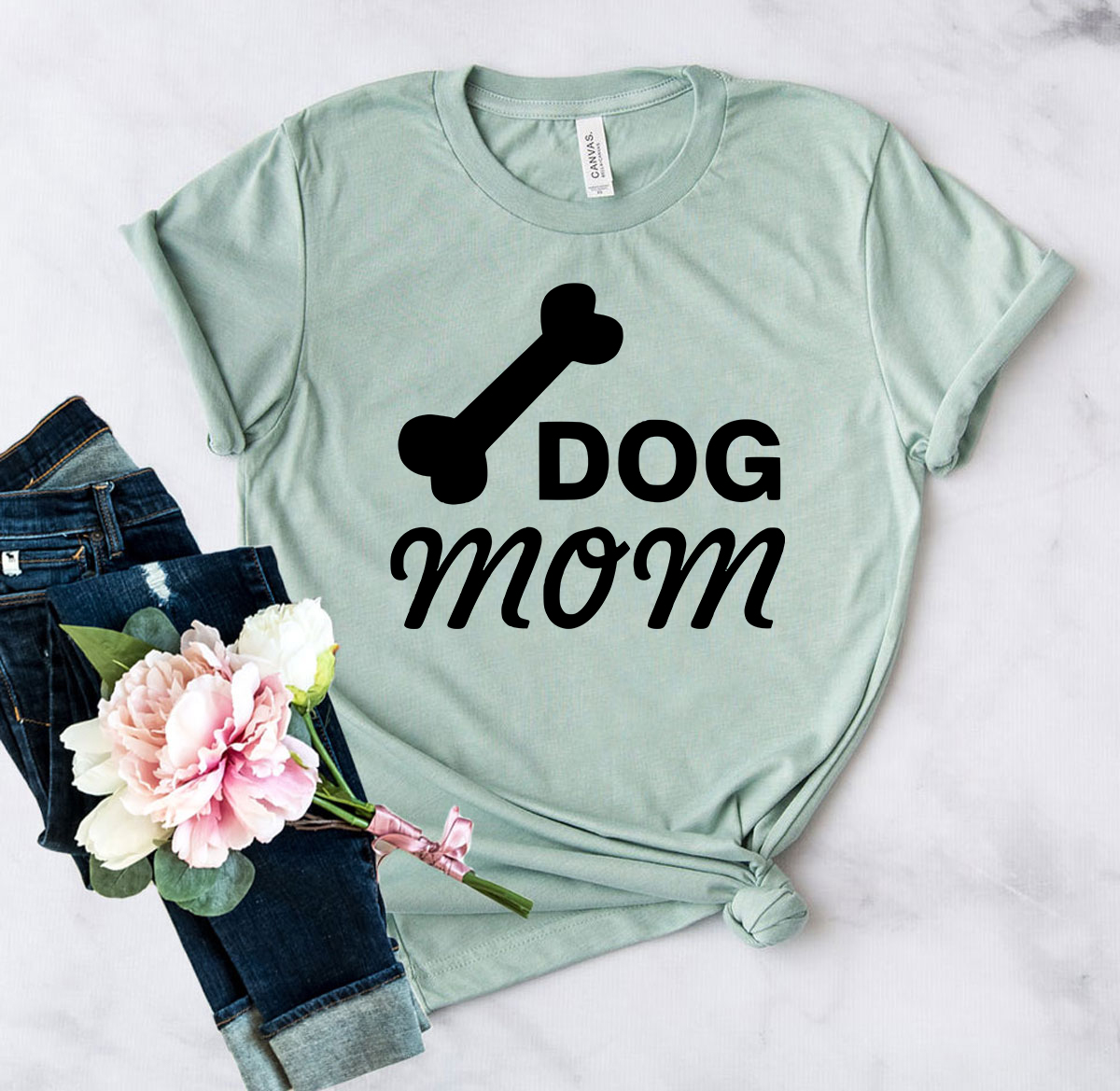 A stylish unisex Dog Mom Shirt made from soft ring spun cotton, available in various colors and sizes.