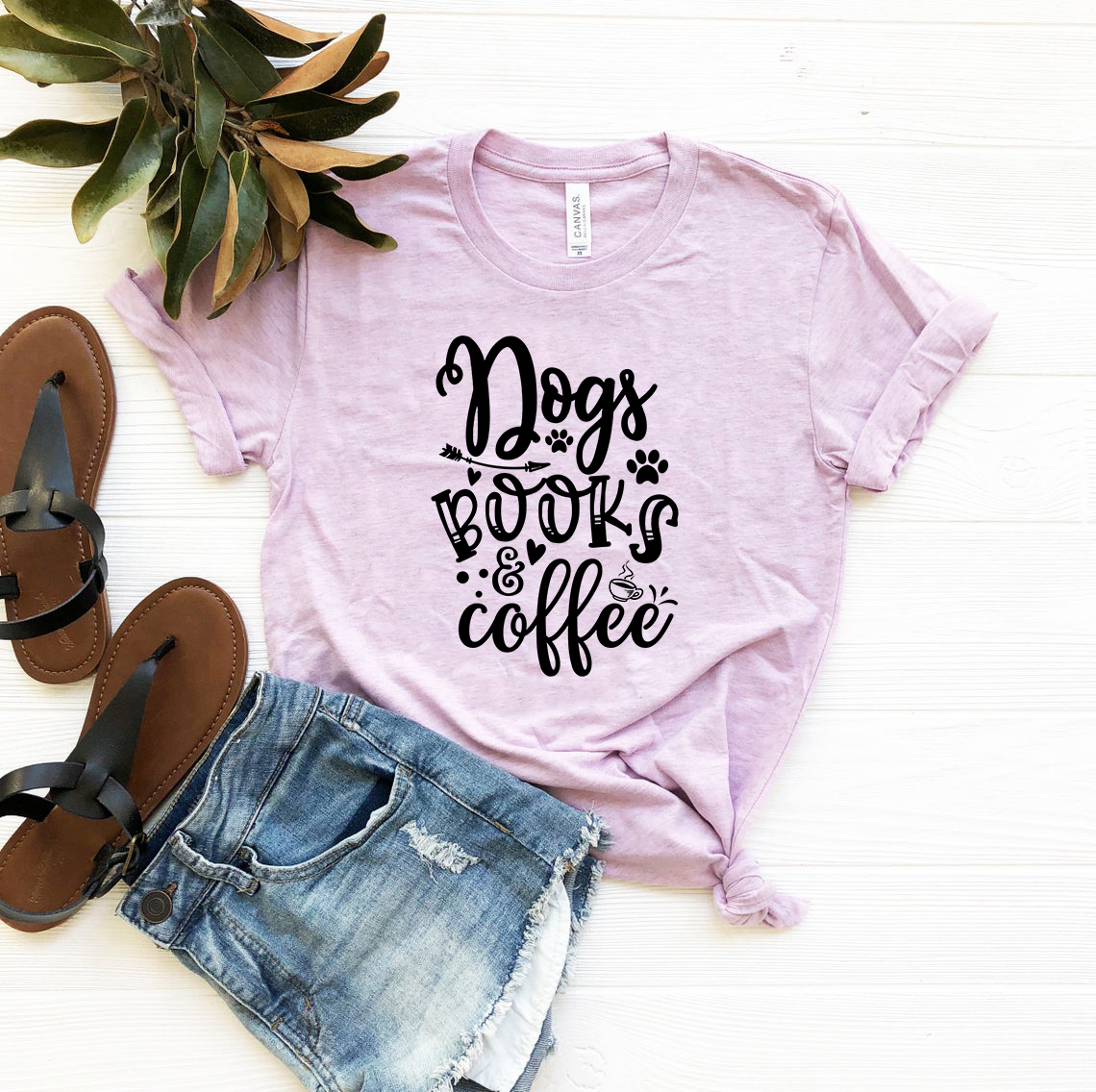 A comfortable unisex T-shirt featuring a design that celebrates dogs, books, and coffee, available in multiple colors.