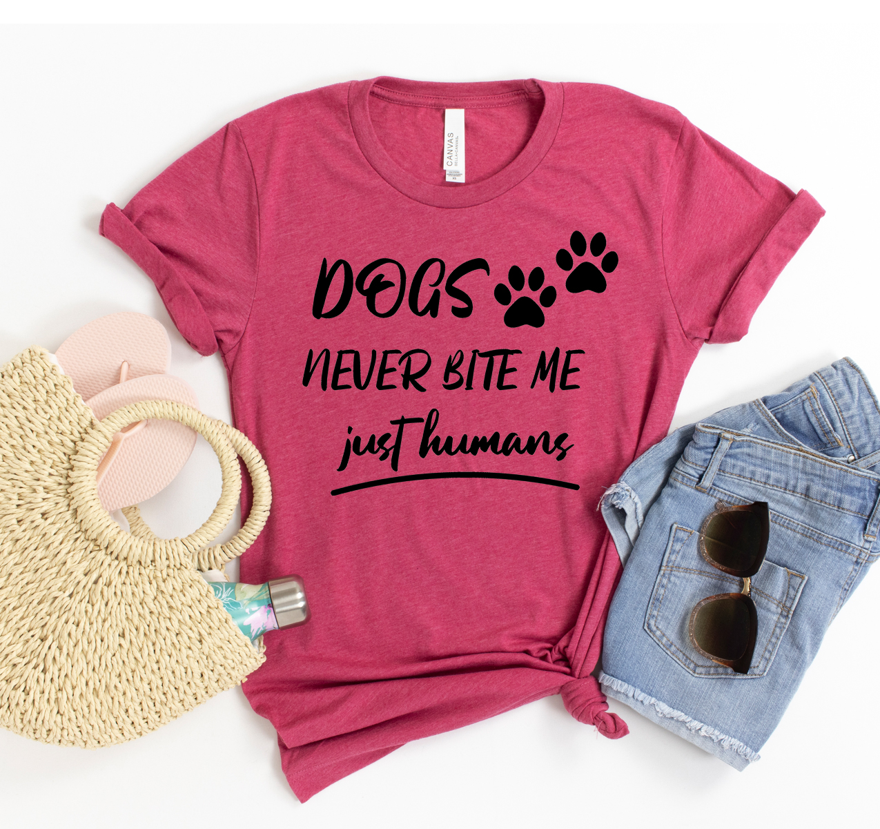 A stylish unisex t-shirt featuring the phrase 'Dogs Never Bite Me Just Humans', made from soft cotton fabric.