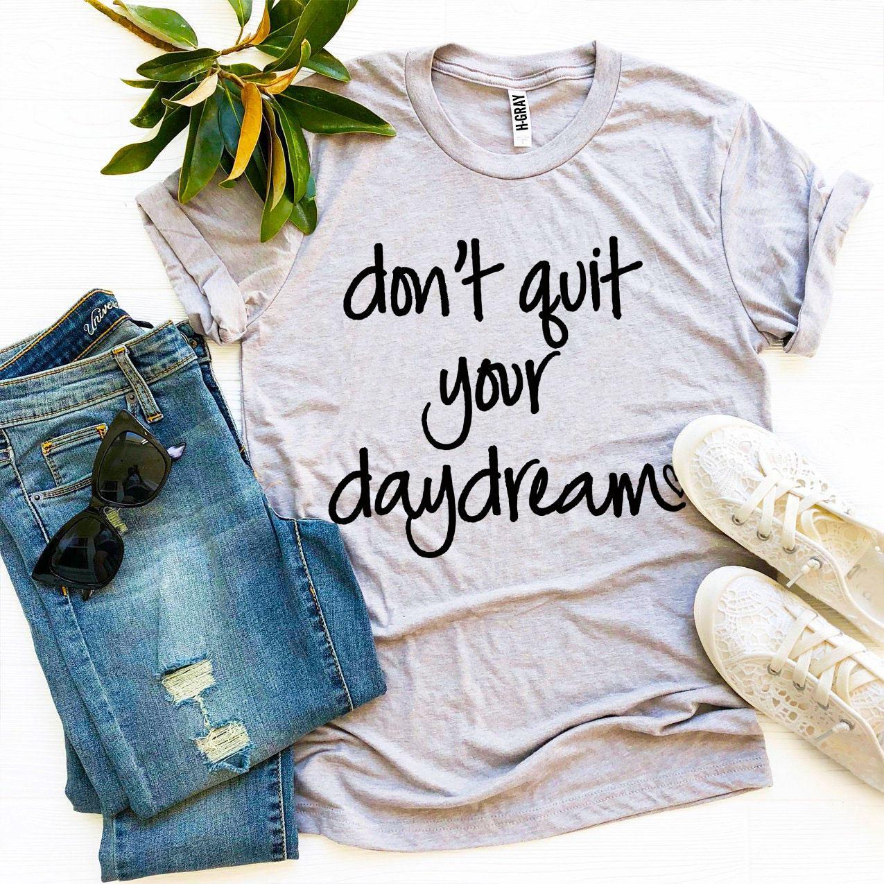 Don’t Quit Your Daydream T-shirt made of premium ring spun cotton with a motivational print, available in various sizes.