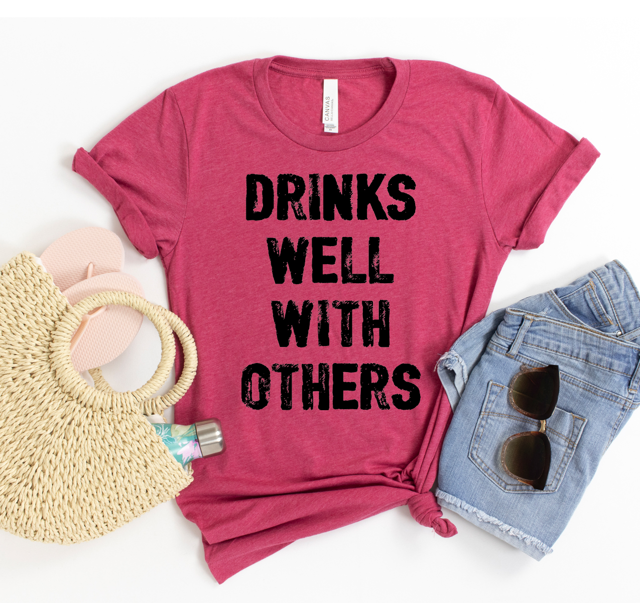 A stylish unisex Drinks Well With Others T-shirt in a vibrant color, showcasing its soft fabric and playful design.