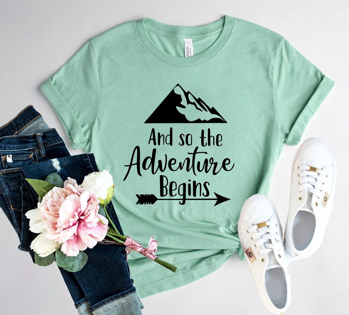 DT0126 And So The Adventure Begins Shirt in various colors, showcasing its comfortable fit and stylish design.