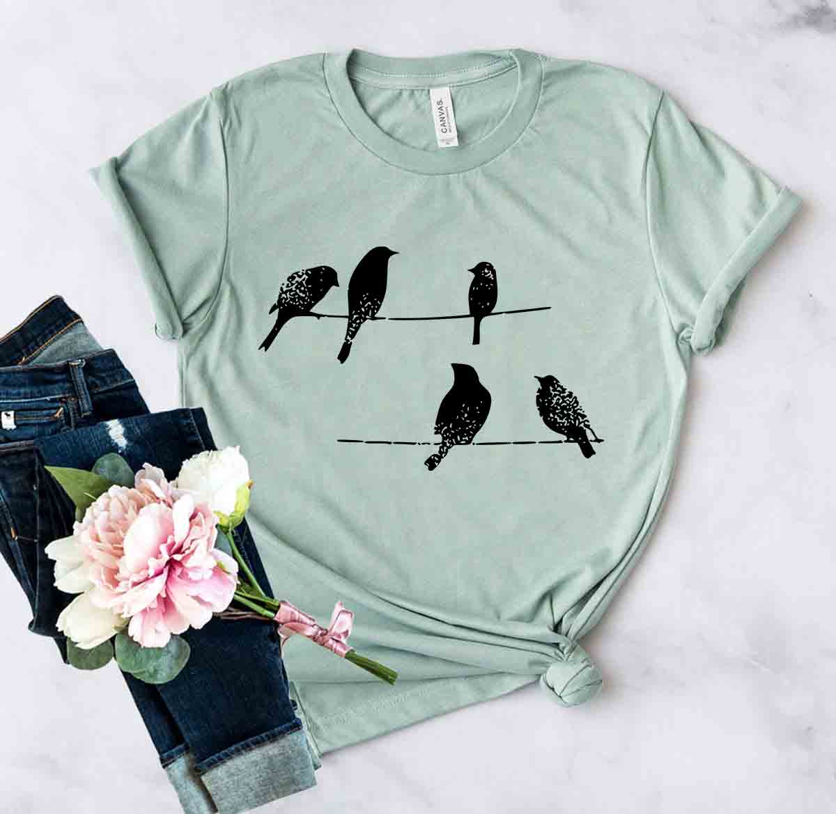 DT0250 Birds On Wire Shirt in various colors, showcasing its comfortable fit and stylish design.