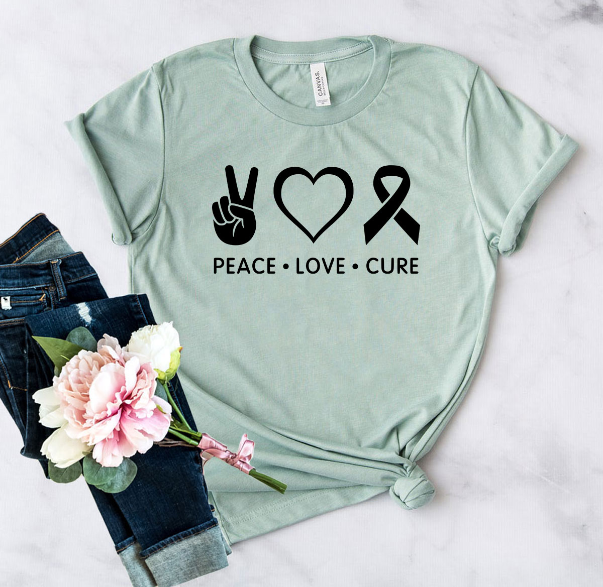 DT0475 Peace Love Cure Shirt in various colors, showcasing its soft fabric and stylish design.