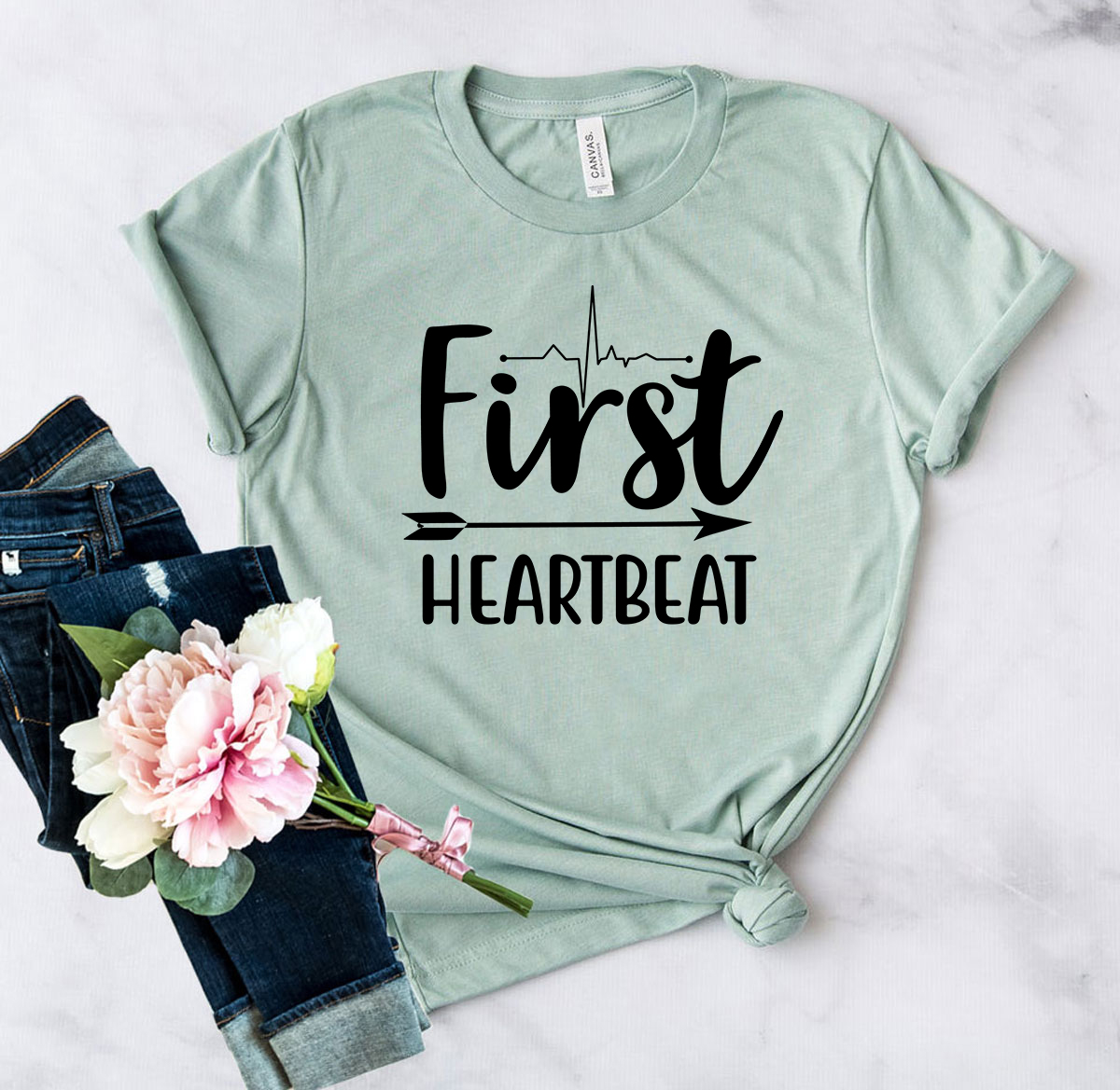 DT0627 First Heartbeat Unisex T-shirt in various colors, showcasing its soft fabric and stylish design.