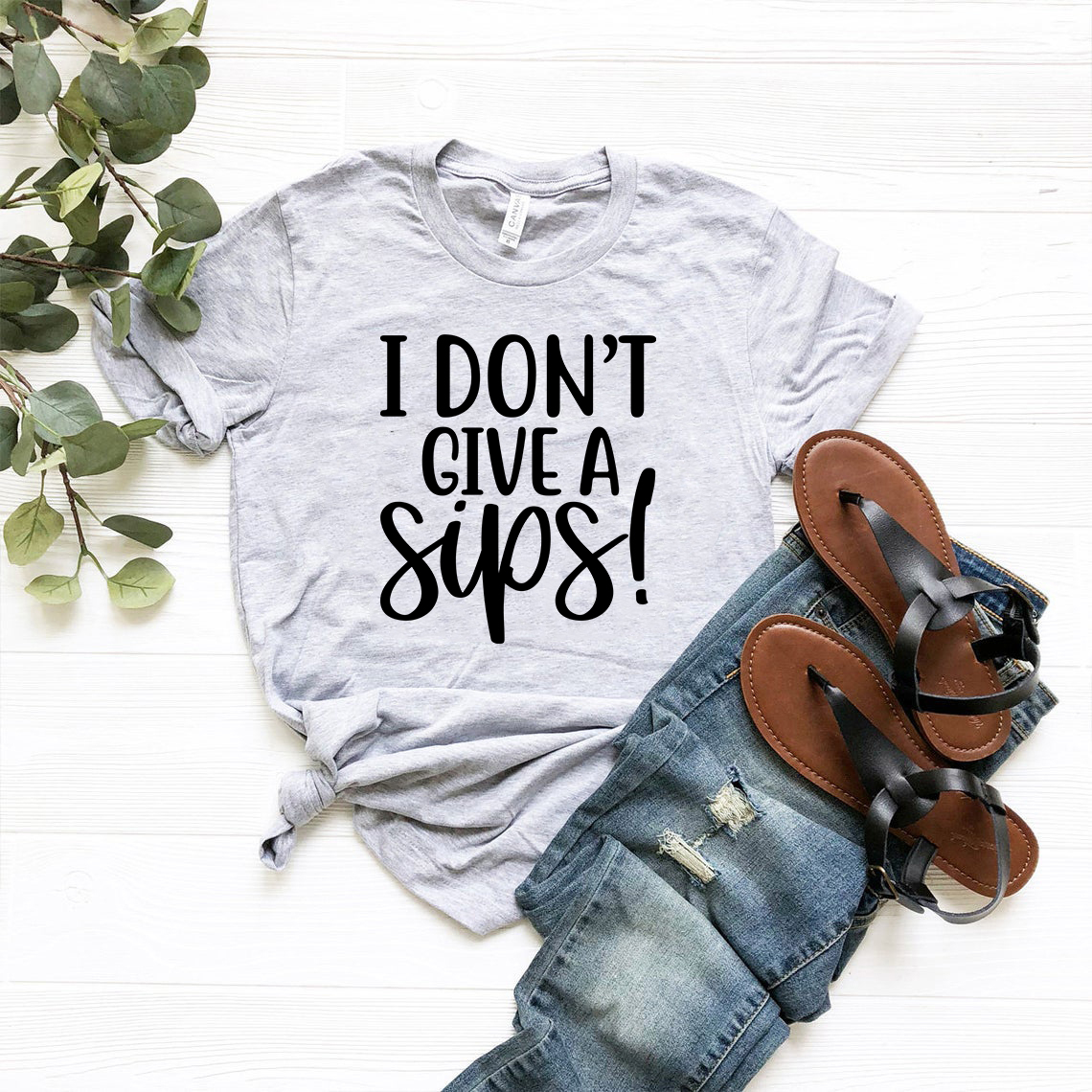 DT0655 'I Don't Give Sips' Unisex T-shirt in various colors, showcasing its comfortable fit and high-quality print.