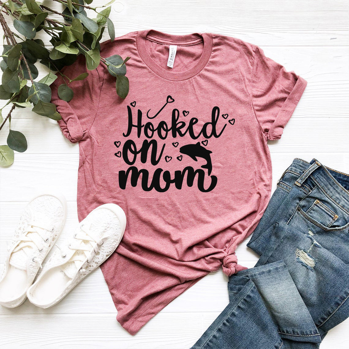 DT0651 Hooked on Mom unisex T-shirt in various colors, showcasing its soft fabric and stylish design.