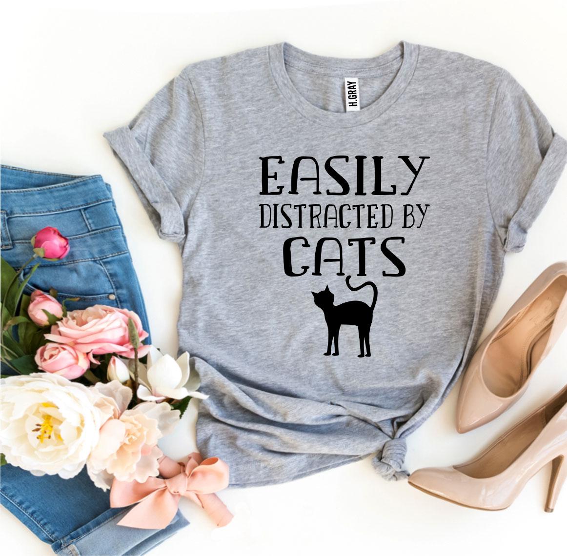 Easily Distracted By Cats T-shirt in various sizes, showcasing its soft cotton fabric and vibrant print design.