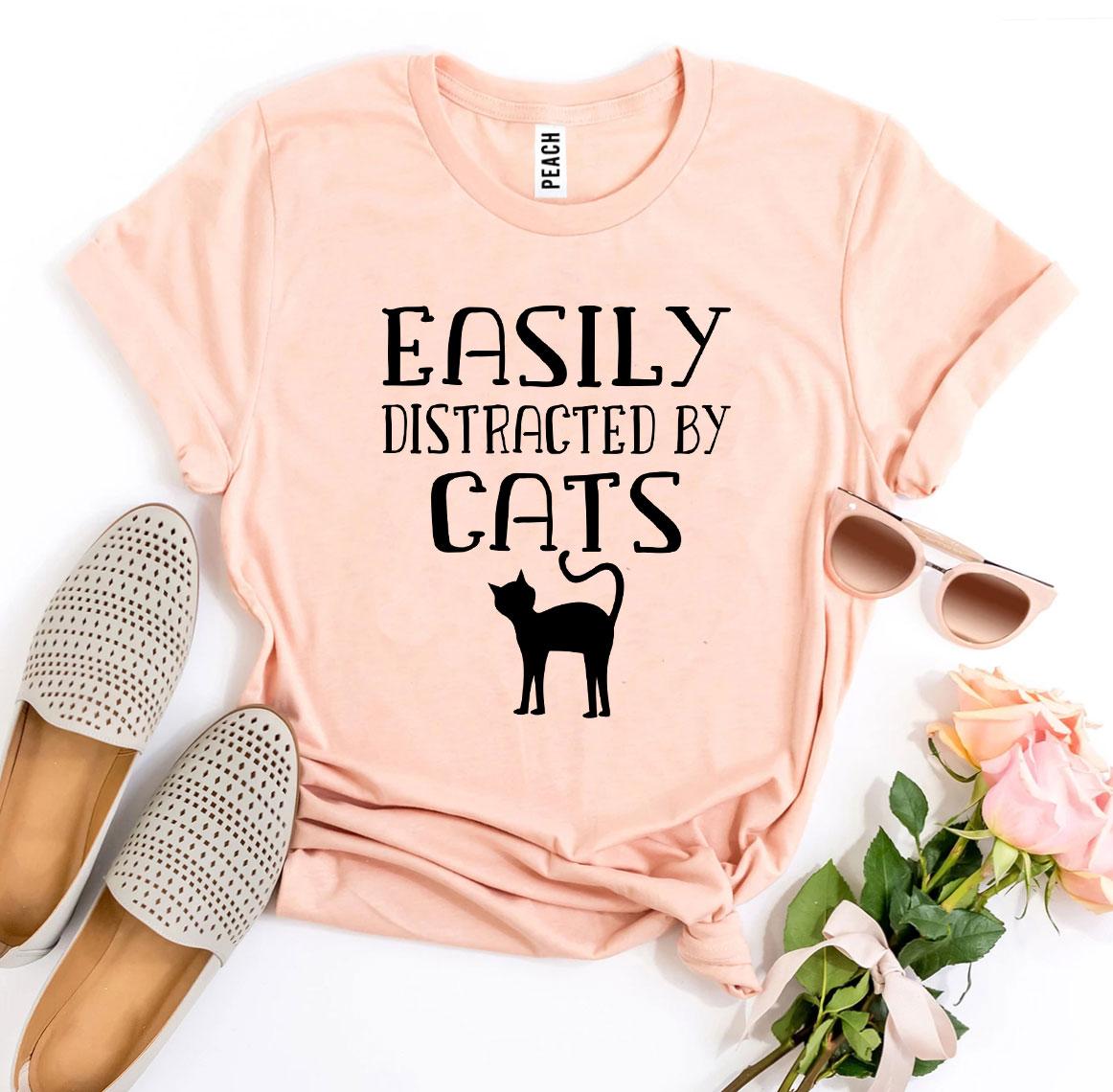 Easily Distracted By Cats T-shirt in various sizes, showcasing its soft cotton fabric and vibrant print design.