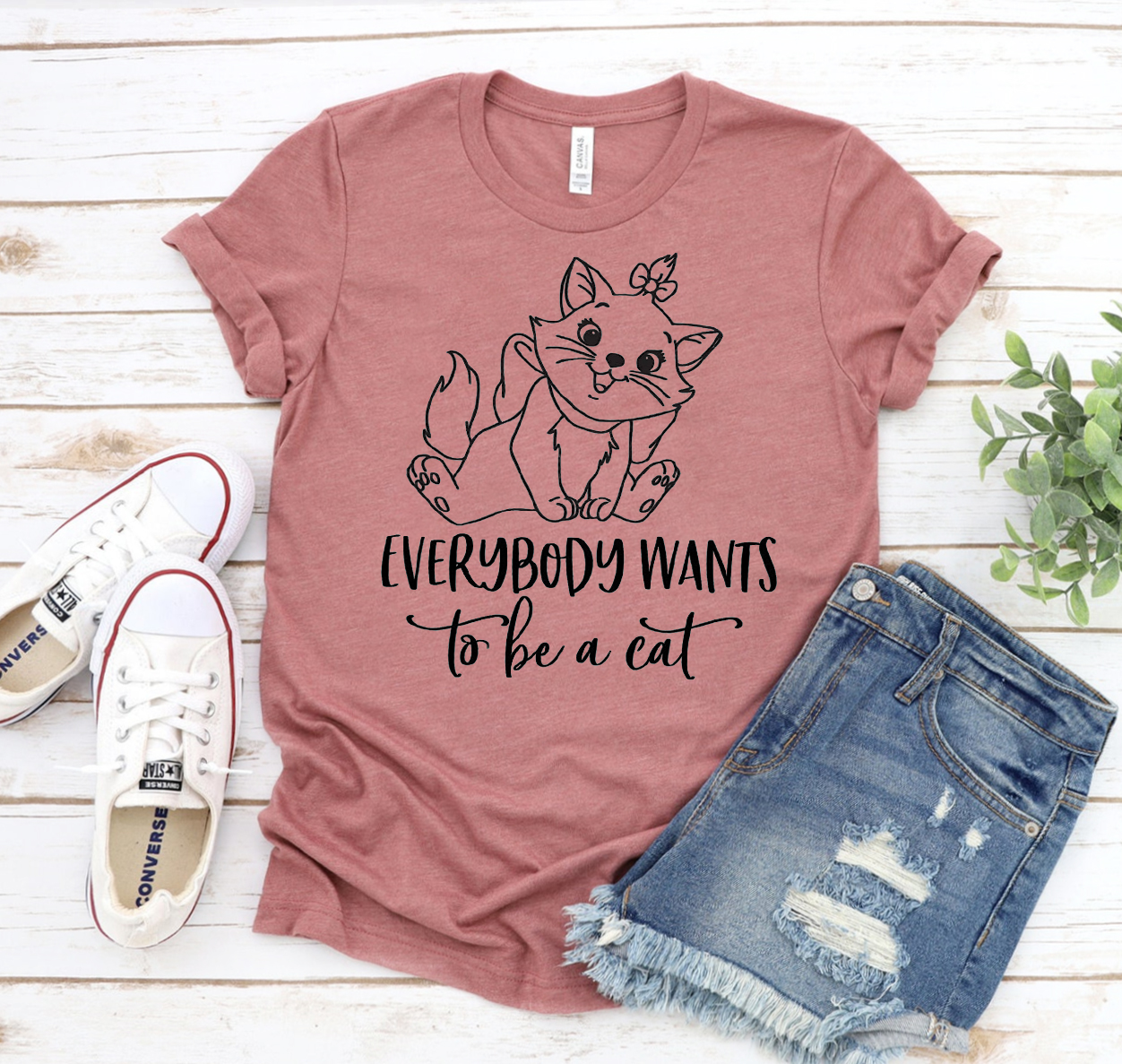 A stylish unisex t-shirt featuring the phrase 'Everybody Wants To Be A Cat', made from soft cotton fabric.