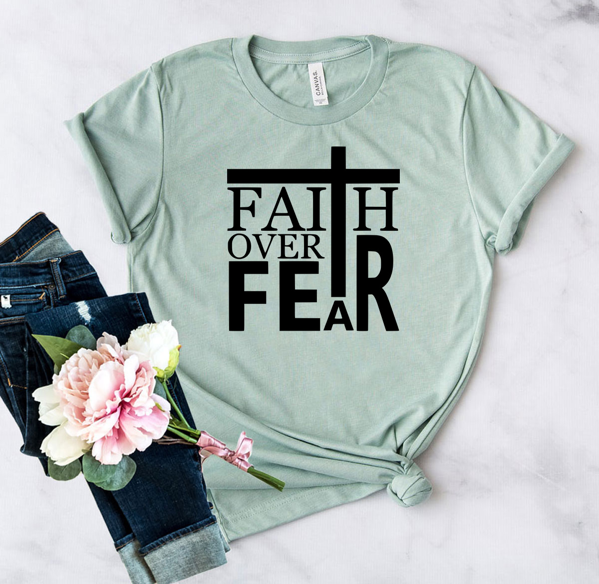 A unisex Faith Over Fear Shirt made from soft ring spun cotton, showcasing its vibrant colors and modern fit.