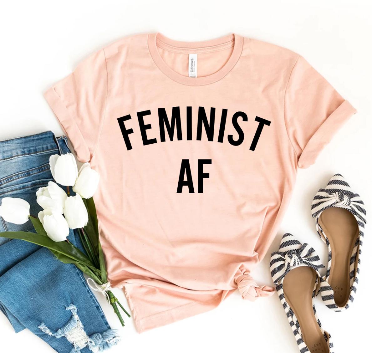 Feminist Af T-shirt made of premium ring spun cotton with a bold design, available in various sizes.