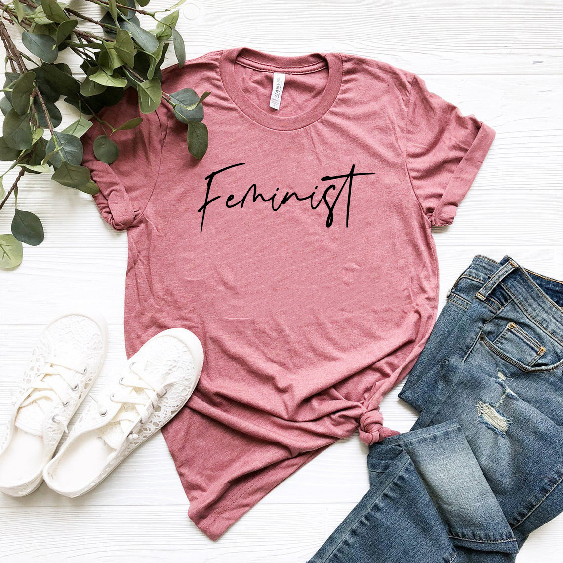 A stylish unisex Feminist Shirt made from soft ring spun cotton, available in various colors and sizes, featuring a classic crew neck design.