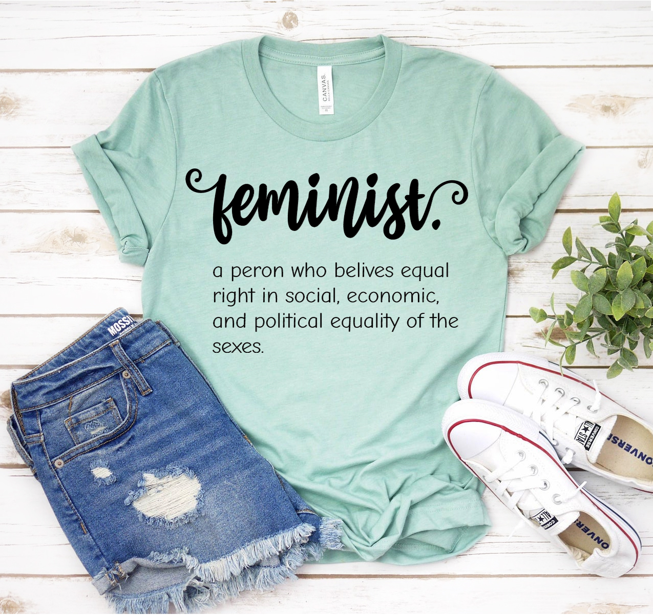 A unisex Bella Canvas 3001 Feminist T-shirt in various sizes, showcasing its soft fabric and stylish design.