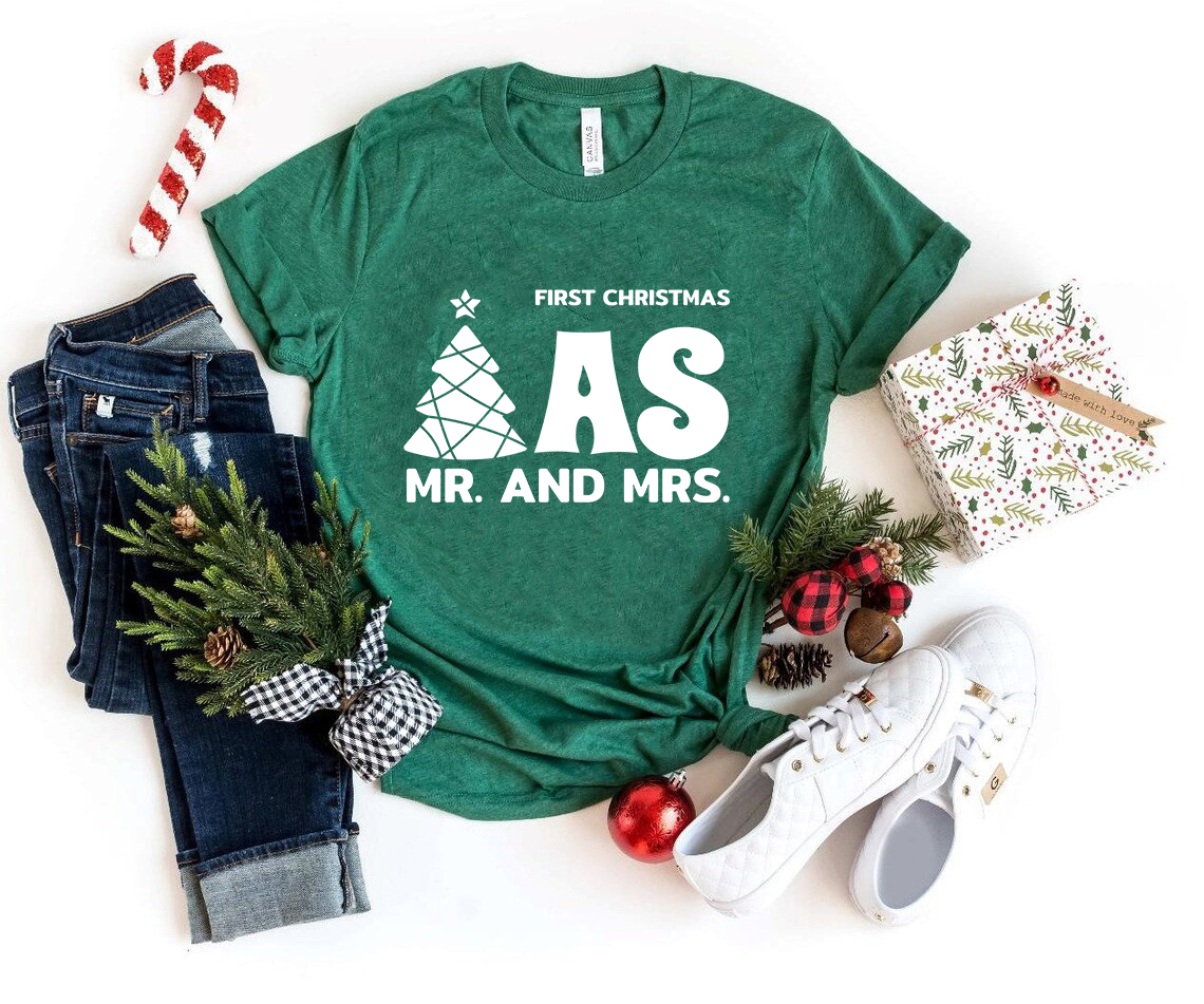 A couple wearing matching First Christmas Mr And Mrs shirts, showcasing festive spirit and holiday cheer.