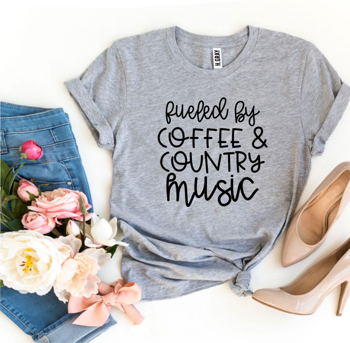 A stylish t-shirt featuring the phrase 'Fueled By Coffee And Country Music' printed in a high-quality flex print on a soft cotton fabric.