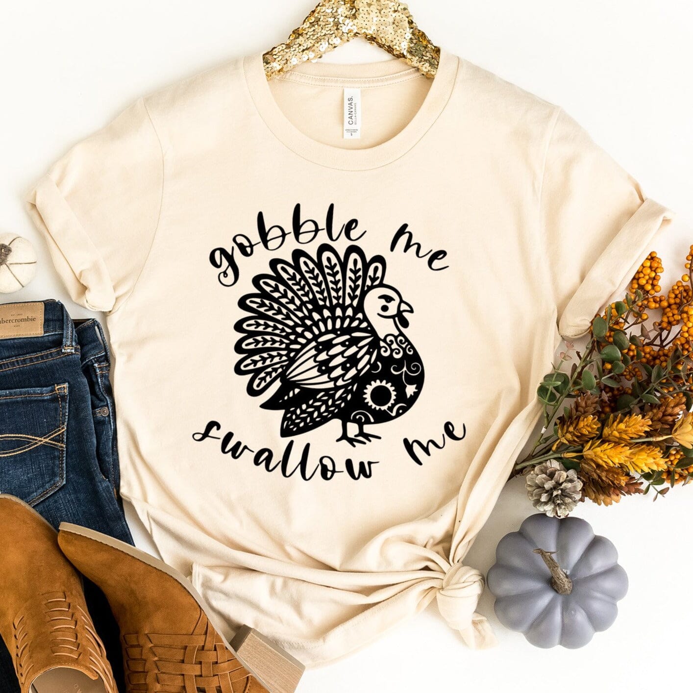 A stylish Gobble Me Tee displayed on a hanger, showcasing its soft fabric and modern fit, perfect for casual wear.