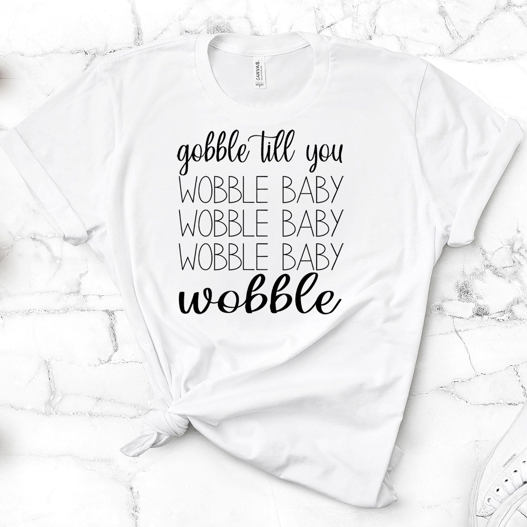 A stylish Gobble Till You Wobble Tee featuring a fun design, made from soft Ringspun Cotton, suitable for both men and women.