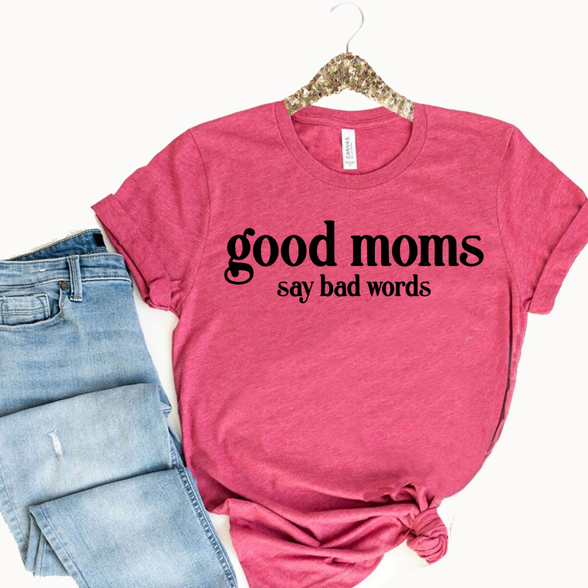 A stylish unisex T-shirt with the phrase 'Good Moms Say Bad Words' printed on it, showcasing its comfortable fit and vibrant color options.