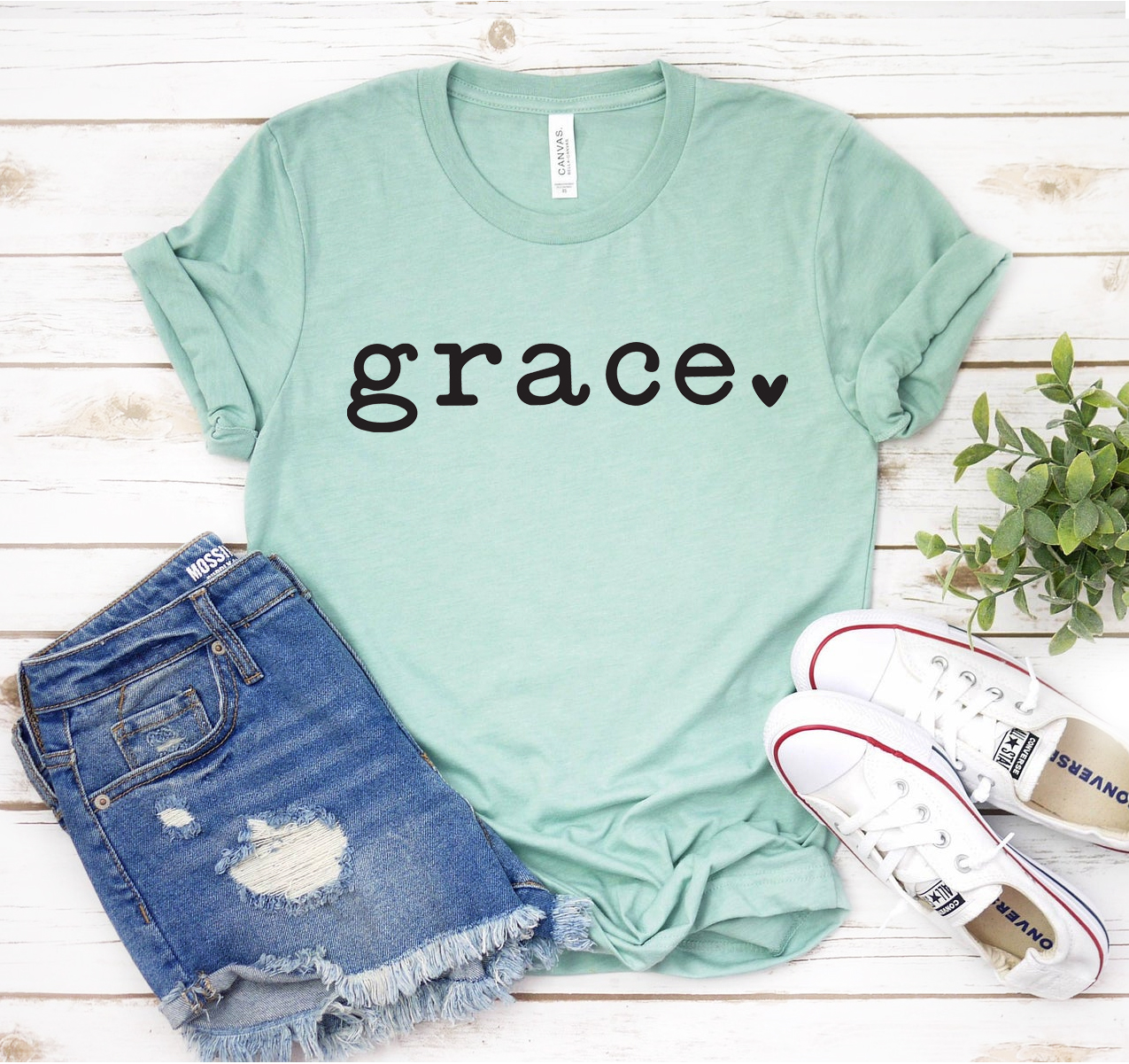 Grace T-shirt in various colors, showcasing its unisex design and soft fabric.