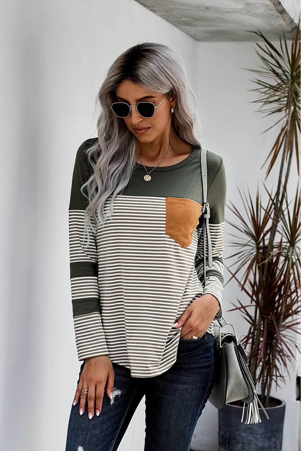 Green pinstripe long sleeve top with patch pocket, featuring a round neckline and stylish design.