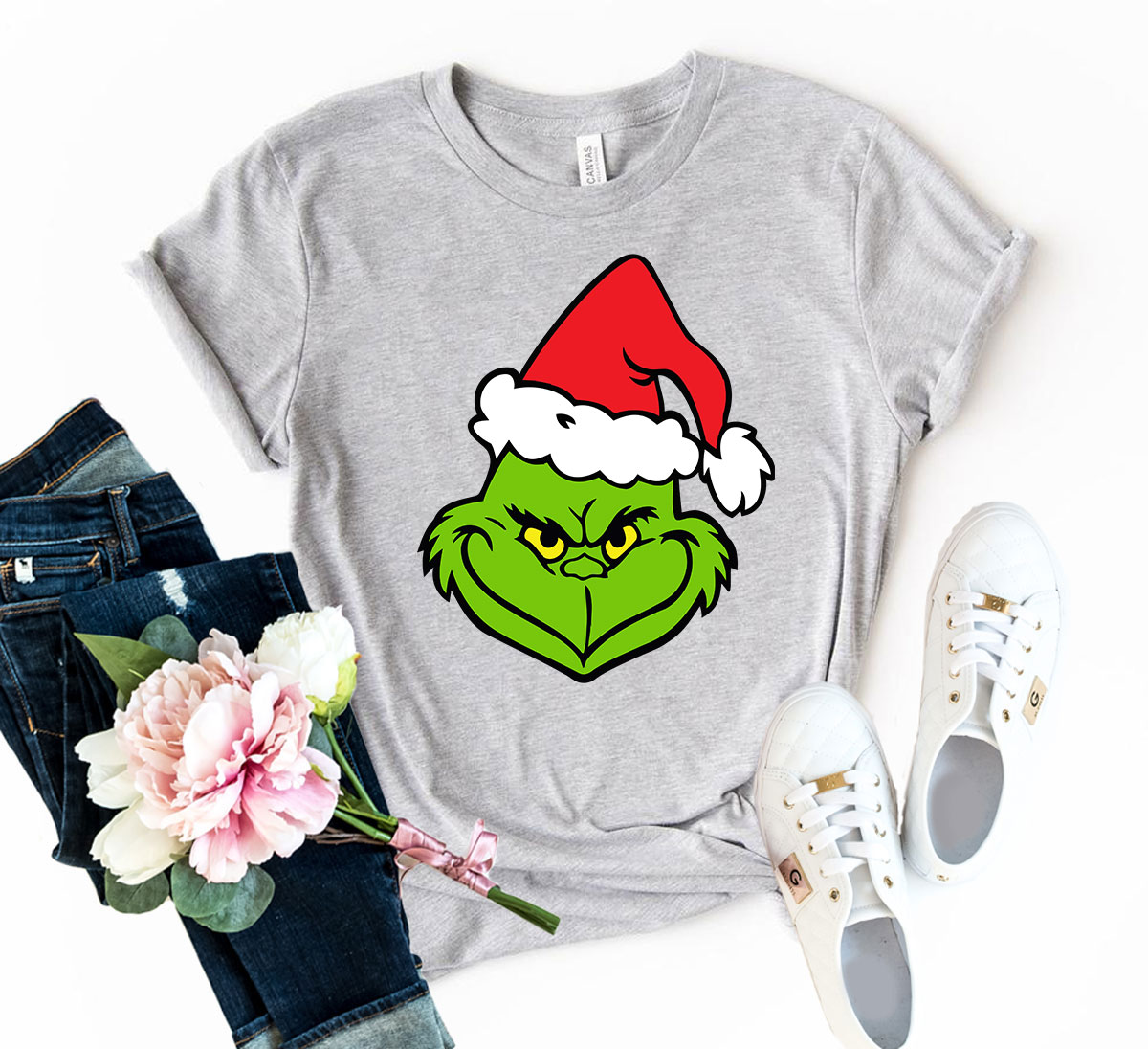 A vibrant Grinch Christmas Shirt made from soft ring spun cotton, featuring a festive Grinch design, available in multiple colors.