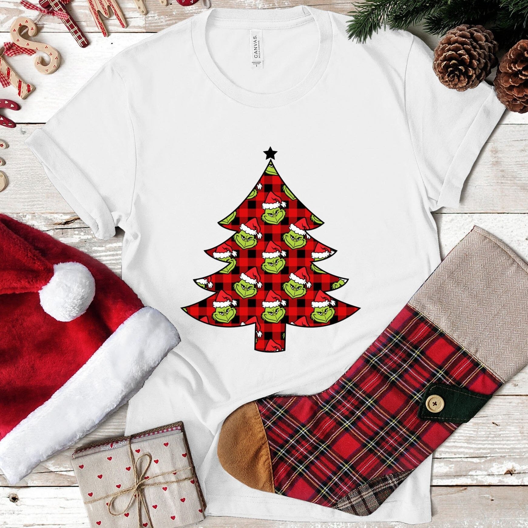 A festive Grinch Christmas Tree Tee featuring a playful design with the Grinch and a Christmas tree, perfect for holiday celebrations.