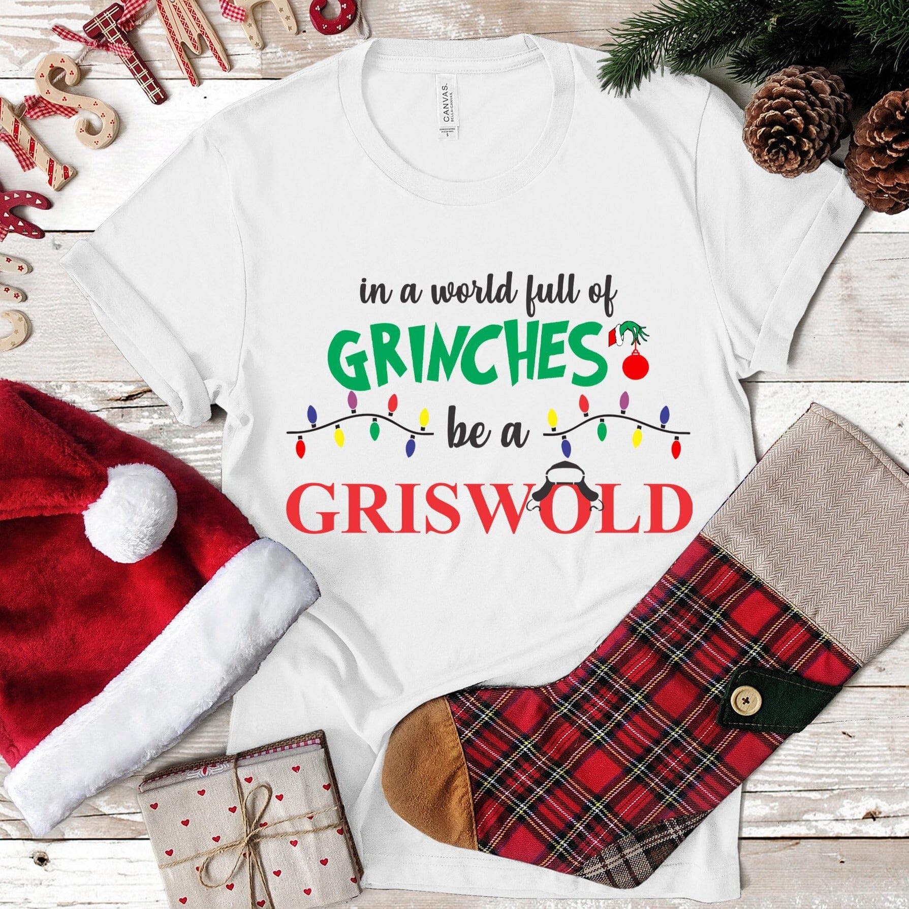 Grinch Griswold Christmas Tee featuring a festive design, made from 100% Ringspun Cotton, perfect for holiday celebrations.